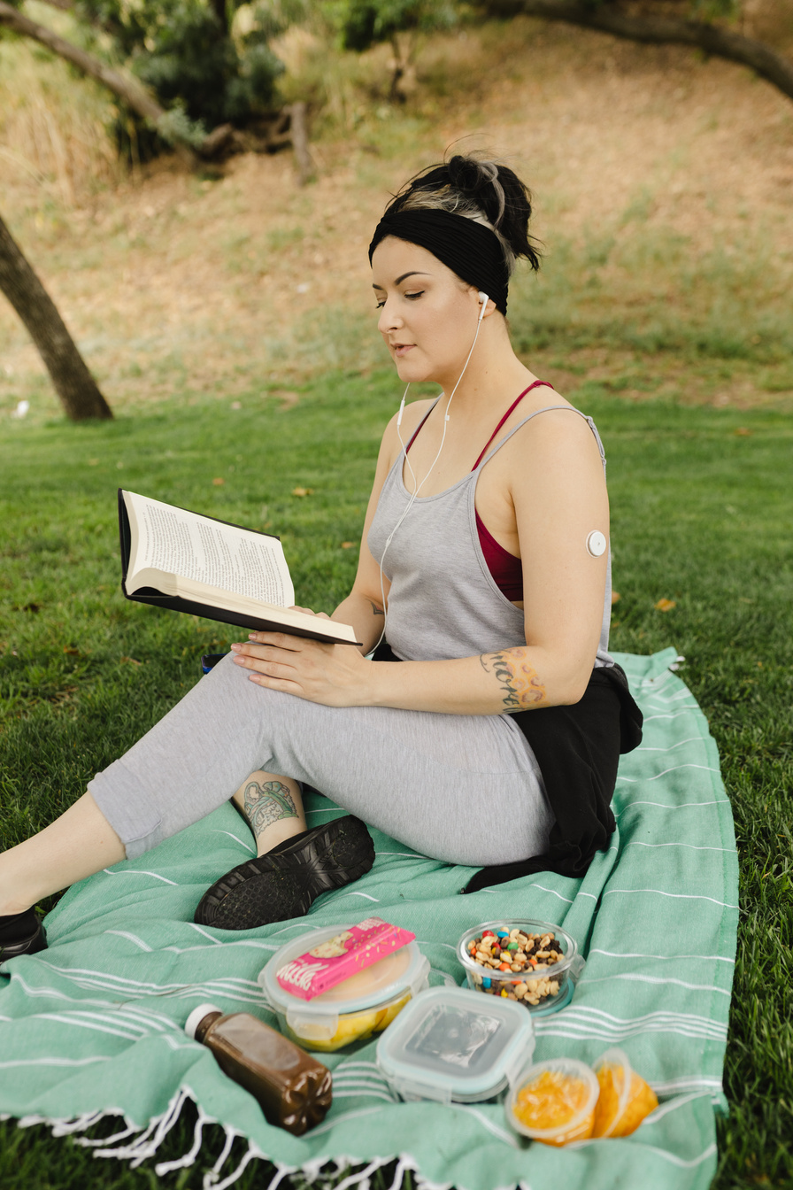 Woman with Diabetes Reading a Book Outdoors